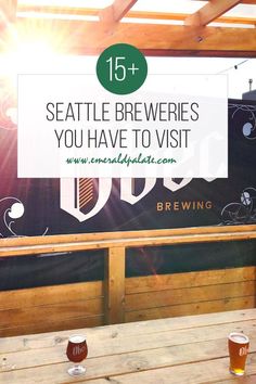 beer glasses sitting on top of a wooden table next to a sign that says seattle brewers you have to visit