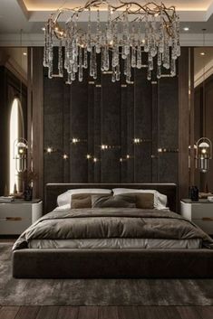 a large bed sitting in a bedroom under a chandelier