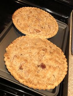 two pies sitting on top of an oven