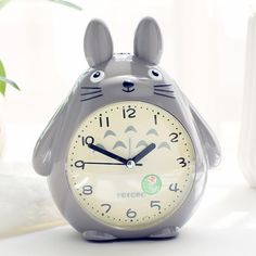 a clock that is shaped like a totoro