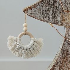 a wooden ring with tassels hanging from it