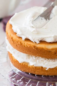 a close up of a cake on a plate with a knife in the frosting