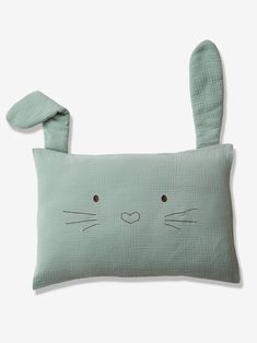 a green pillow with a bunny face on it