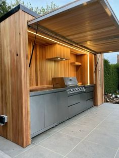 an outdoor kitchen is built into the side of a house