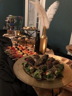 an assortment of desserts and snacks on a table in front of a wine bottle