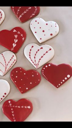 some red and white heart shaped cookies on a table