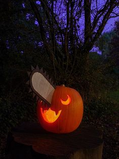 a carved pumpkin with a knife stuck in it