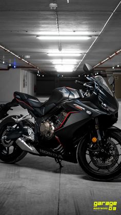 a black motorcycle parked in a parking garage