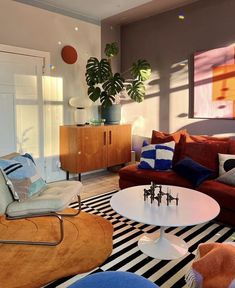 a living room filled with furniture and a potted plant