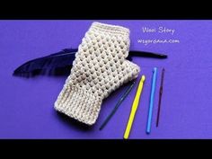 crochet gloves, pencils and markers on a purple surface