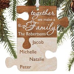 a wooden ornament hanging from a christmas tree with the words together we make a family