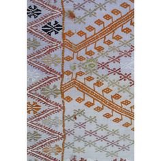 an orange and white rug with different designs on the front, side and back sides