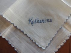 This lovely vintage white organdy handkerchief, about 12" square, features the embroidered name "Katherine" and a scalloped edge detail in a pretty blue shade. There are no stains or other issues. The hanky has been carefully laundered and pressed. Please look closely at the photos and convo me with any questions. I pack carefully and ship same or next business day from Arkansas with free tracking. Satisfaction guaranteed or money cheerfully refunded. Diy Handkerchief, White Embroidered Handkerchiefs As Gift, Blue Embroidered Handkerchief For Wedding, Vintage Handkerchiefs With Embroidered Border As Gift, Classic Embroidered Handkerchiefs For Wedding Gift, Handkerchief Monogram, Vintage Handkerchief With Embroidered Border As Gift, Classic White Embroidered Handkerchiefs, Vintage Handkerchiefs