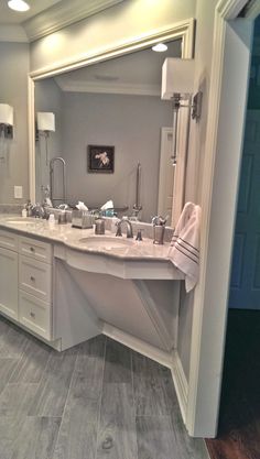 a large bathroom with two sinks and mirrors