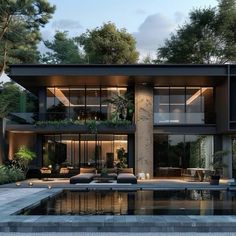 a modern house with an outdoor pool in the foreground and lots of greenery