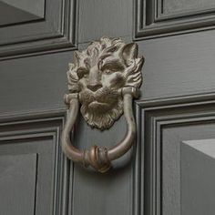 a close up of a door handle with a lion's head on the front