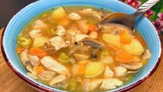 a blue bowl filled with soup on top of a wooden table