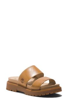 Crafted with responsibly sourced leather, this two-strap slide sandal offers walkable comfort with OrthoLite® cushioning, a faux-suede lining and a lug sole. 1 1/2" heel OrthoLite footbed Leather upper/textile lining/rubber sole Imported Timberland Leather Sandals With Cushioned Footbed, Casual Leather Timberland Sandals, Timberland Leather Sandals With Removable Insole, Timberland Leather Open Toe Sandals, Timberland Sandals For Summer Beach, Timberland Summer Sandals With Cushioned Footbed, Leather Double Strap Slides For Spring, Timberland Synthetic Sandals For Spring, Casual Timberland Sandals For The Beach