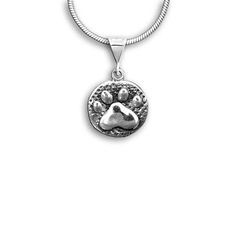 "There is nothing like sterling silver paw print jewelry to express the love you have for your pet! I designed this piece to be a beautiful recognition of the human animal bond. I personally love the pet paw symbol for just that reason. And of course, in a stylized version like this it can represent a dog or a cat. I've also created a pair of matching earrings just like this piece. If you prefer smaller post earrings, I do have those as well. This pendant is 9/16\" across. The Magic Zoo's unique Silver Paw Print Round Pendant Necklace, Sterling Silver Jewelry With Paw Print, Silver Jewelry With Paw Print, Sterling Silver Paw Print Necklace, Paw Pendant, Paw Jewelry, Unique Sterling Silver Jewelry, Human Animal, Paw Print Jewelry