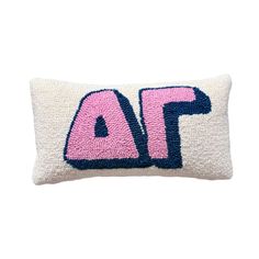 a pink and blue pillow with the word af in it's letters, on a white background