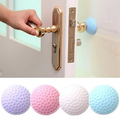 three door knobs with different colored balls on the front and back of each door