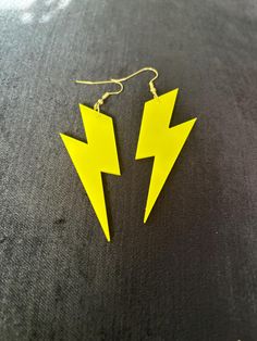 pair of yellow lightning earrings on black background