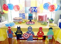 an image of a birthday party setting with legos and balloons on the table in front of it