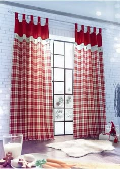 a red and white checkered curtain hanging in front of a window next to a wooden table