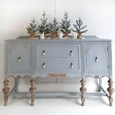 an old dresser with some plants on top