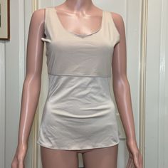 Large Light Beige Spanx By Sara Blakely Sleeveless Shapeware Tank Size: L Chest: 90% Polyester 10% Spandex / Elastane Body: 79% Polyester 21% Spandex / Elastane About 22” Long Armpit To Armpit (Bust): 16” Arm Hole Width: 7” Waist: 13" Bottom Hem Width: 16" No Stains, Tears Or Holes At All Excellent As Nwot Condition Clean And Smoke Free Home Quick Shipping- All Items Are Shipped Daily As Long As Usps Is Open. Make Me Offers! Message Me With Any Questions! You Like More Than One Item In My Closet Fitted Tank Vest With Built-in Bra, Shapewear Tank Top With Built-in Bra And Wide Straps, Beige Crochet Tank Top, Fitted Cream Tank Top With Built-in Bra, Summer Shapewear Camisole With Built-in Bra, Fitted Beige Tops With Built-in Bra, Beige Stretch Vest Top, Sleeveless Stretch Shapewear With Medium Bust Support, Sleeveless Stretch Shapewear With Built-in Bra