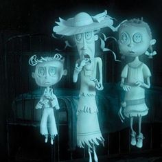 three creepy dolls standing next to each other