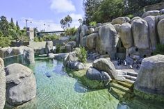 an artificial pond surrounded by large rocks and boulders