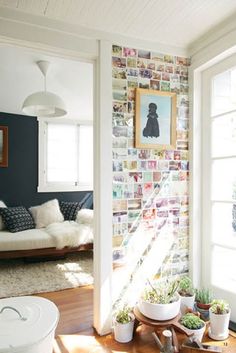 a living room filled with furniture and pictures on the wall behind it's windows