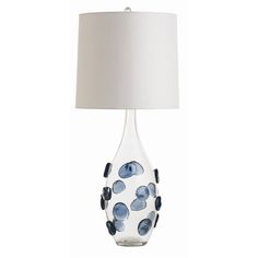 a blue and white lamp with a shade on it