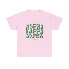 a pink t - shirt with green letters on it