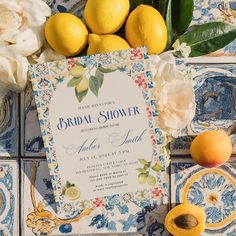 the wedding stationery is surrounded by lemons and flowers