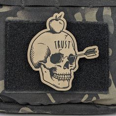 a skull with an apple on its head and arrow in it's back pocket