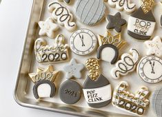 a tray filled with lots of decorated cookies