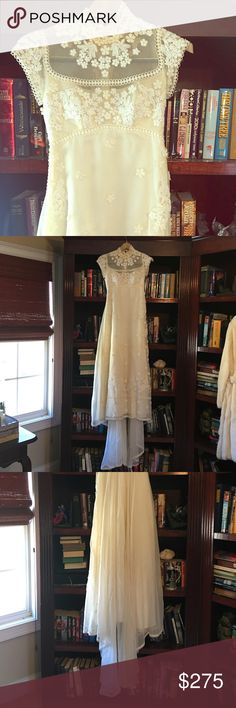 wedding gowns are displayed in front of bookshelves