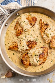 chicken with gravy in a pan on a table