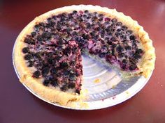 a blueberry pie with one slice missing from it