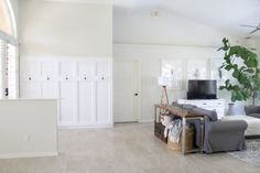 a living room filled with furniture and a flat screen tv