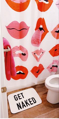 a bathroom with pink and orange lips on the shower curtain