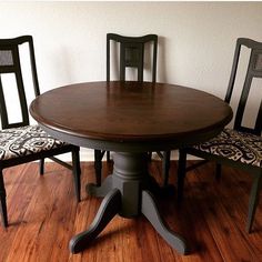 a wooden table with four chairs around it