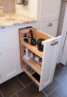 an open cabinet in the middle of a kitchen