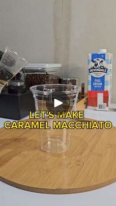 a wooden cutting board sitting on top of a counter next to a bottle of coffee