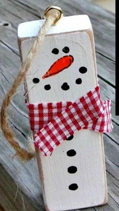 a wooden block with a snowman painted on it