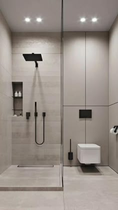 a bathroom with a walk in shower next to a white toilet and black faucet