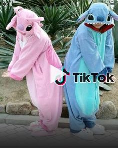 two people in animal onesuits standing next to each other with one wearing a shark costume