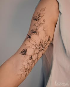 a woman's arm with flowers on it